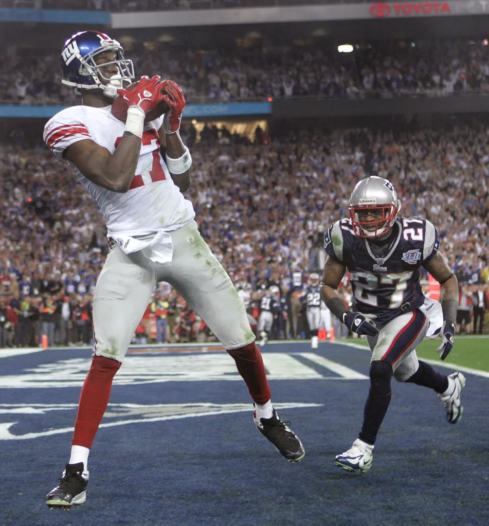 Former Giants receiver Plaxico Burress catches a game-winning pass from Eli Manning in Super Bowl 42.
