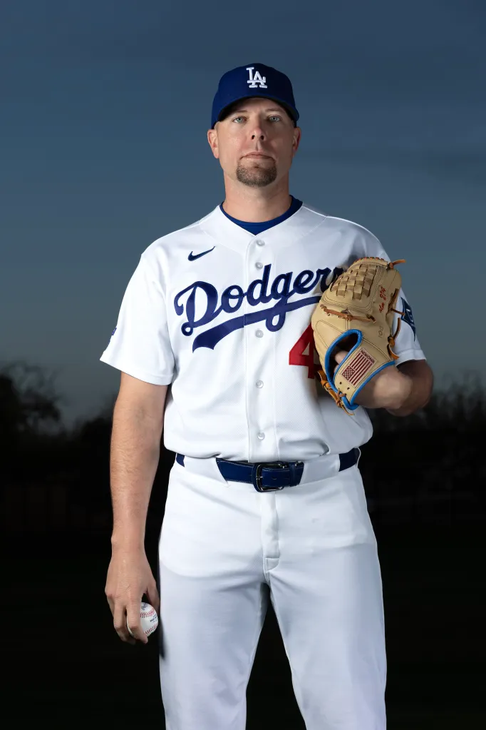 Dodgers pitcher Blake Treinen in uniform posing with a baseball and glove.