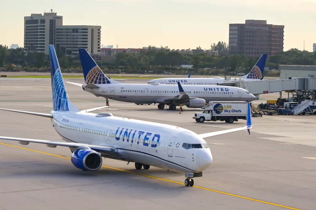 Three United Airlines Boeing 737 aircraft on the tarmac at Miami International Airport.