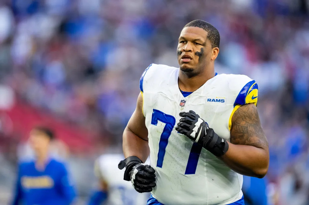 Rams offensive tackle Alaric Jackson (77) running off the field at halftime.
