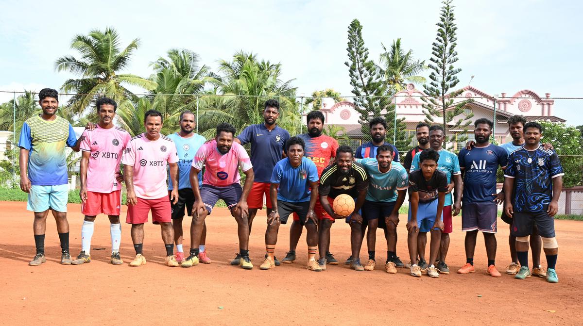 Local residents come together as a football team at a ground in Eraviputhenthurai coastal village in Kanniyakumari district