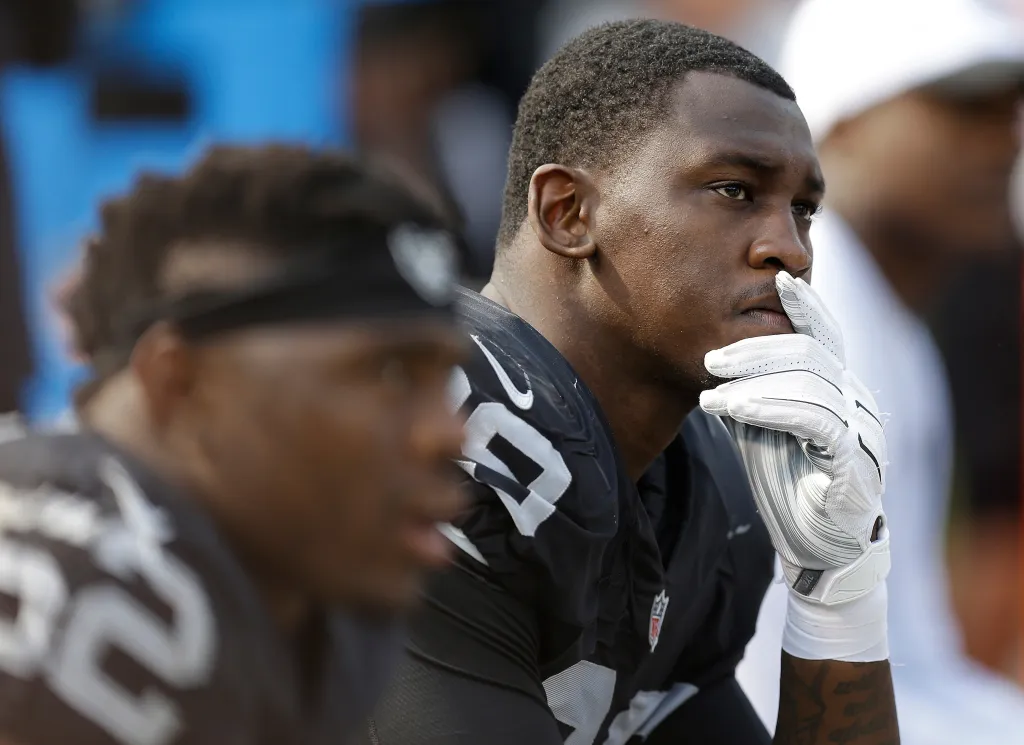 Oakland Raiders linebacker Aldon Smith sits on the bench.