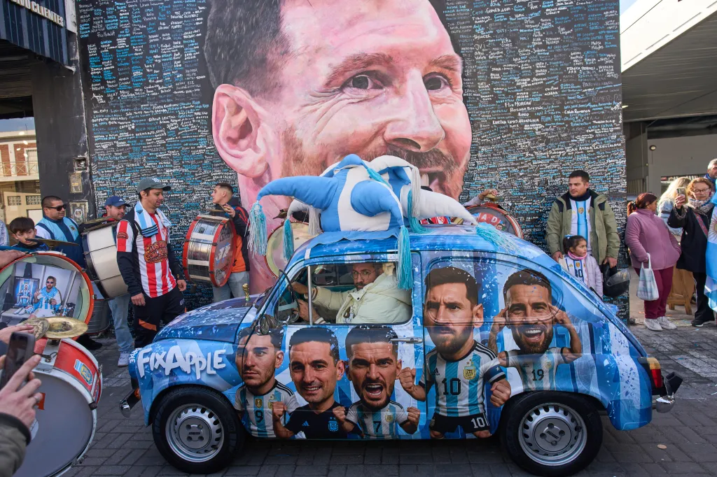 People gather to sing happy birthday to Lionel Messi at a street mural of him in Buenos Aires, Argentina, Wednesday, June 24, 2026.