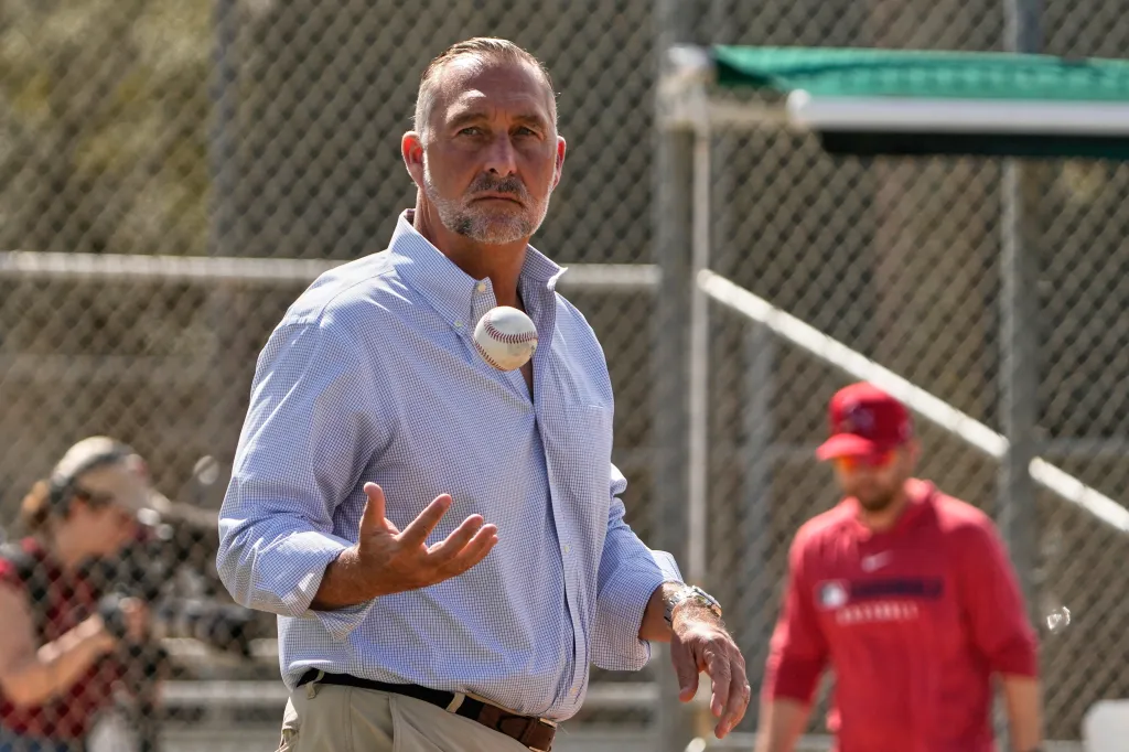John Mozeliak, President of Baseball Operations for the St. Louis Cardinals, tossing a baseball.