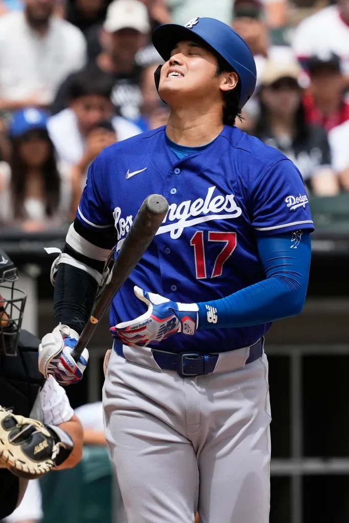 Shohei Ohtani looking up with a bat over his shoulder.