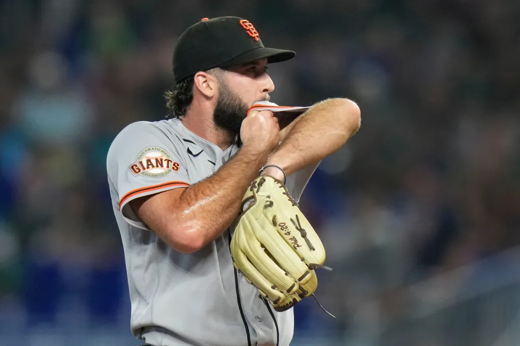 Trevor McDonald, a baseball pitcher for the San Francisco Giants, wiping his face with his shirt.