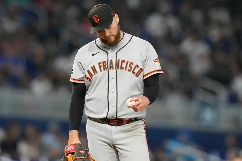 Matt Gage, pitcher for the San Francisco Giants, looking down while holding a baseball.