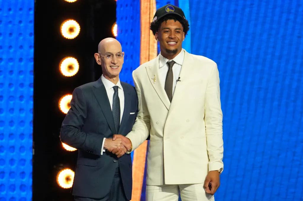 Adam Silver and Yaxel Lendeborg shake hands on stage.