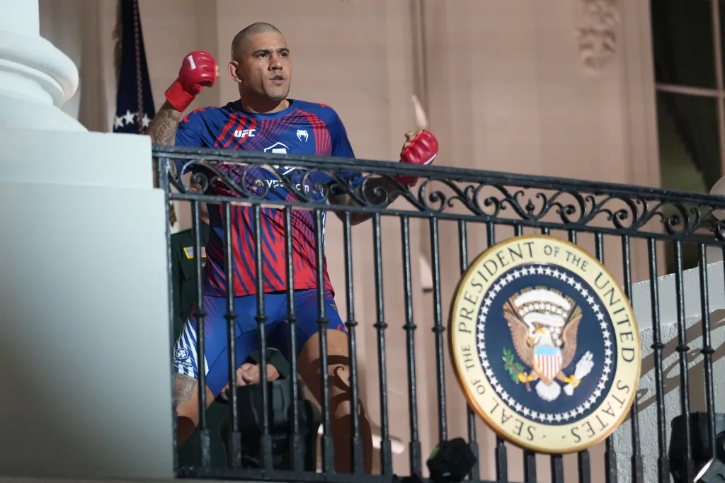 Alex Pereira in a blue and red UFC shirt on the White House's balcony.
