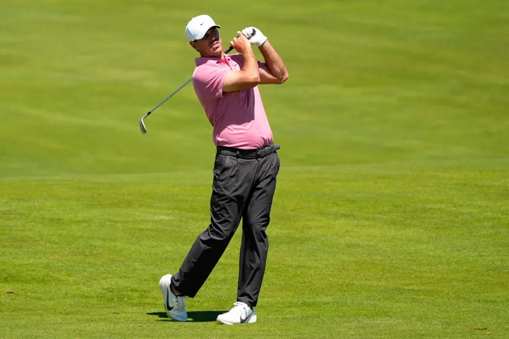 Brooks Koepka hits from the fairway on the 13th hole during a practice round for the U.S. Open golf tournament at Shinnecock Hills Golf Club in Southampton, N.Y., Tuesday, June 16, 2026.