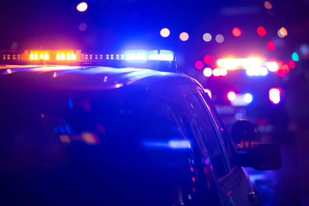 Emergency lights from a police unit at night.