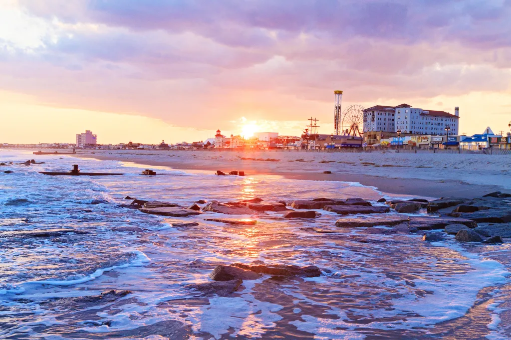 Sunset over the Ocean City, New Jersey beach, boardwalk, and skyline.