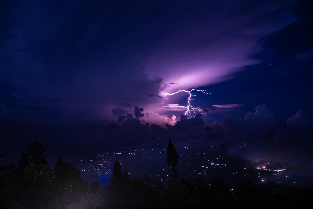 A dramatic lightning strike cuts through the sky during a thunderstorm. in West Bengal’s Sittong
