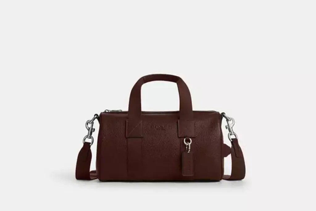 A brown leather duffle bag