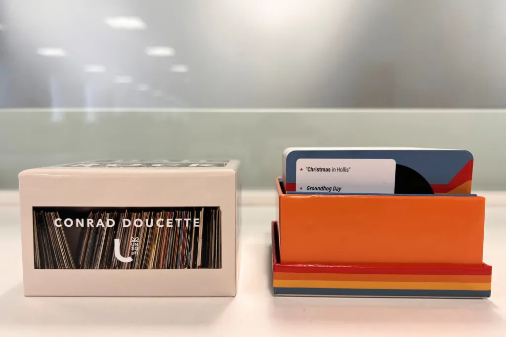 A photo of an open trivia box with cards.
