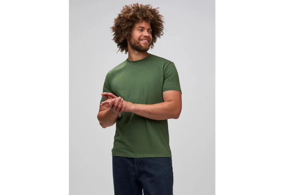 A man wearing a green tee and black pants.