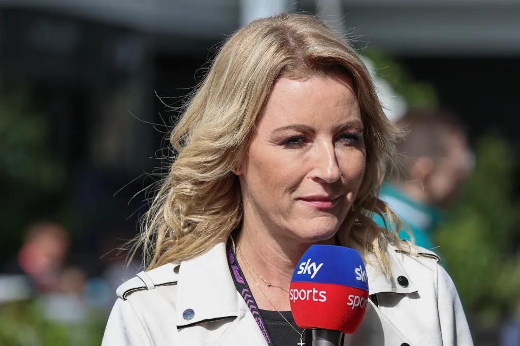 A woman with blonde hair holds a "Sky Sports" microphone.