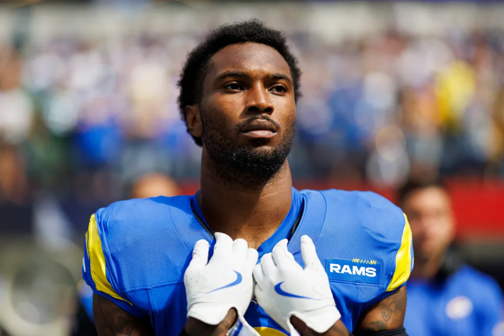Football player in a blue and yellow Rams uniform.
