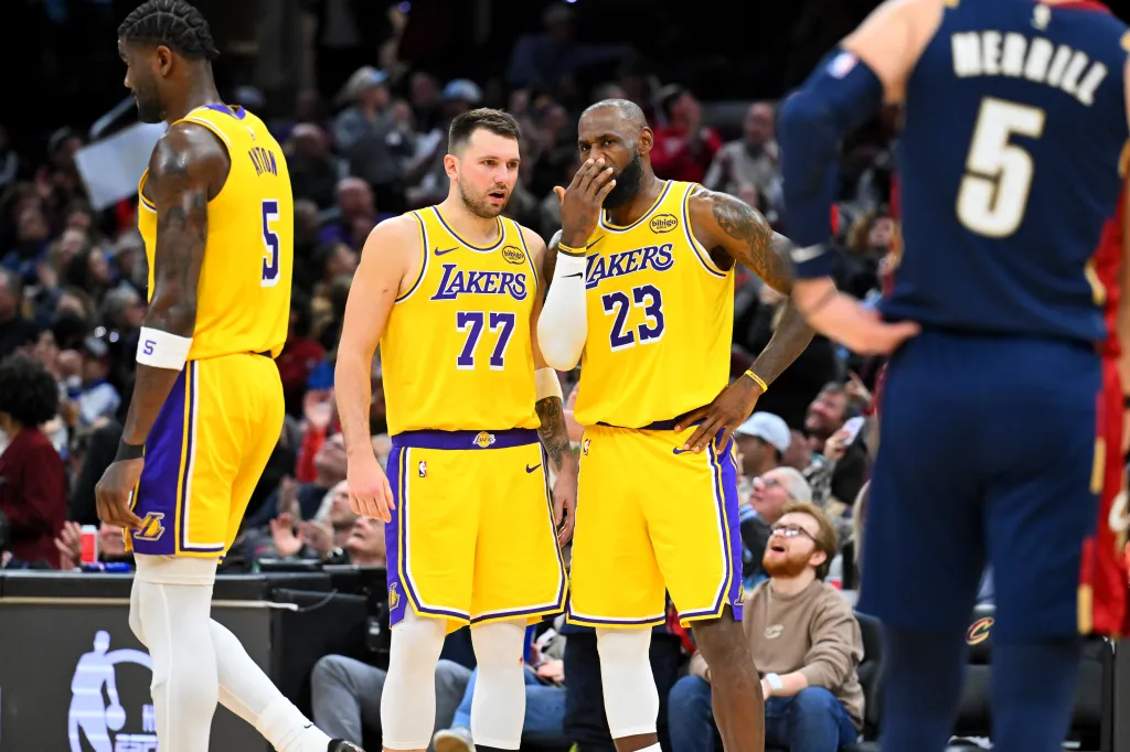 LeBron James and another Lakers player standing on the court, engaged in conversation.
