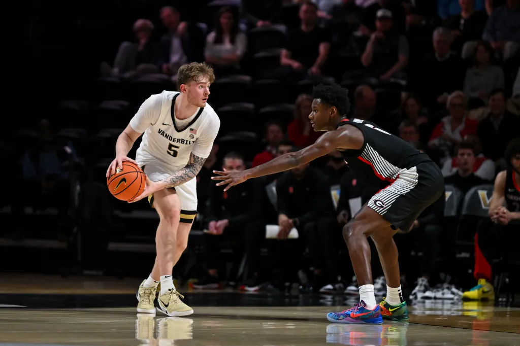 Tyler Nickel #5 of the Vanderbilt Commodores holds the ball against Kanon Catchings #6 of the Georgia Bulldogs