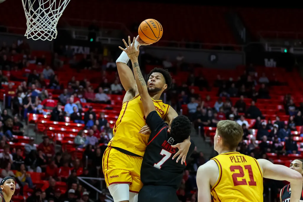Joshua Jefferson #5 of the Iowa State Cyclones goes to lay the ball in against Josh Hayes #7 of the Utah Utes