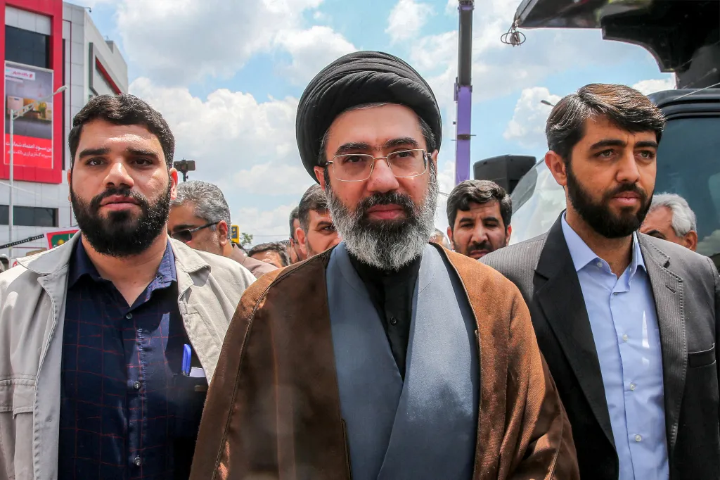 In this picture obtained from Iran's ISNA news agency, Mojtaba Khamenei (C), son of Iran's supreme leader Ayatollah Ali Khamenei, walks along a street in Tehran on May 31, 2019.