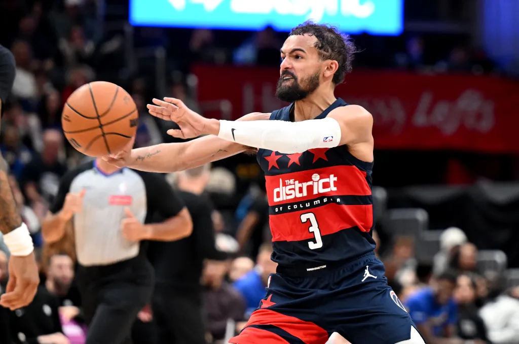 Trae Young #3 of the Washington Wizards passes the ball in the third quarter against the Golden State Warriors at Capital One Arena on March 16, 2026 in Washington, DC. 