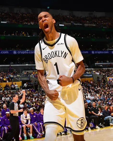 Brooklyn Nets player, wearing jersey number 1, shouts with excitement while clenching his fists.