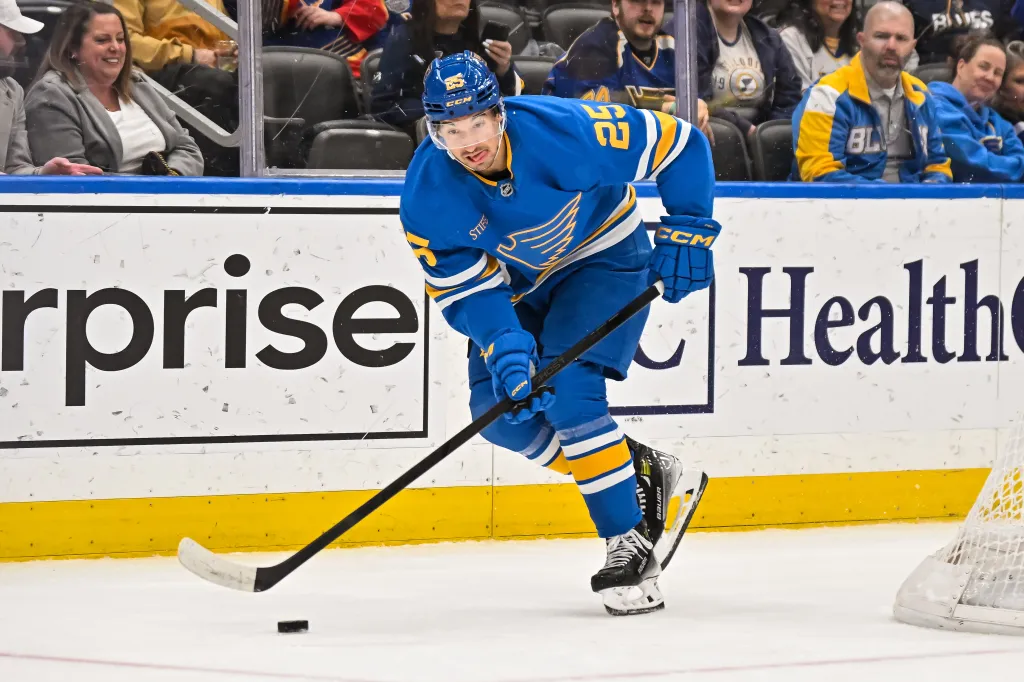St. Louis Blues right wing Jordan Kyrou (25) skates the puck out from behind the net during an NHL game where the St. Louis Blues hosted the Winnipeg Jets on April 9, 2026, at the Enterprise Center.