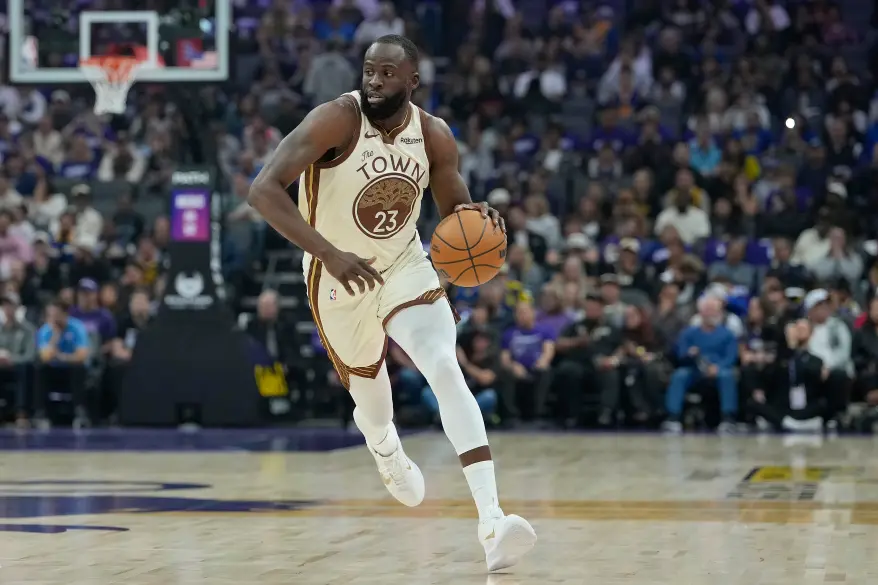 Draymond Green dribbling a basketball on a court.