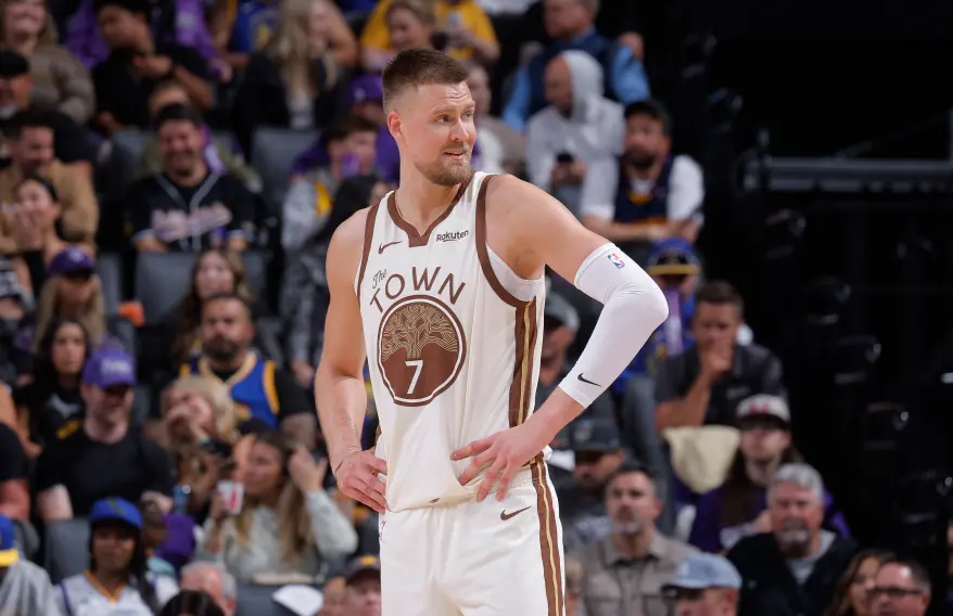 Golden State Warriors player Domantas Sabonis in a white and brown jersey with "The Town" written on it.