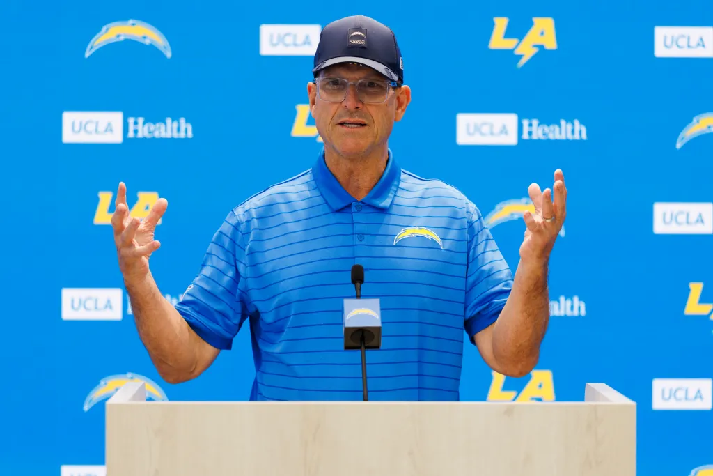 Los Angeles Chargers coach Jim Harbaugh speaking at a press conference.