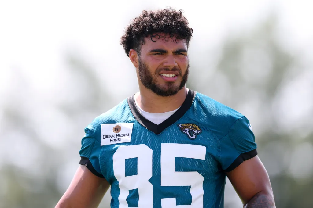 A Jacksonville Jaguars player in a teal jersey with the number 85 visible.