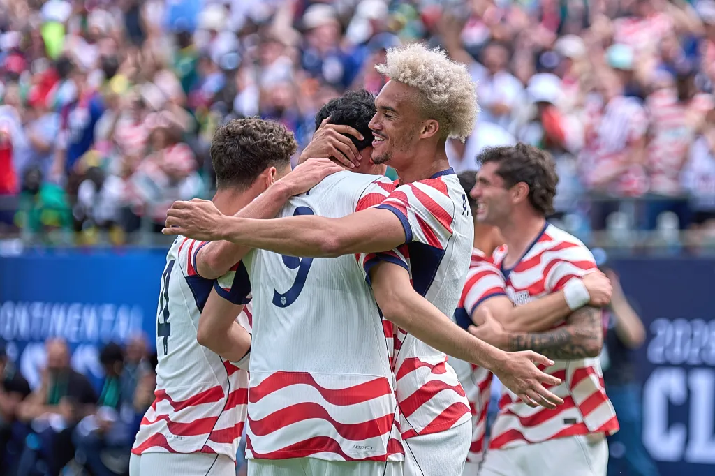 Antonee Robinson (5) celebrates with Tyler Adams (4) and Ricardo Pepi (9) of Team USA. 