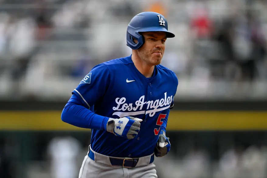 Freddie Freeman wearing a blue Los Angeles Dodgers uniform, running.