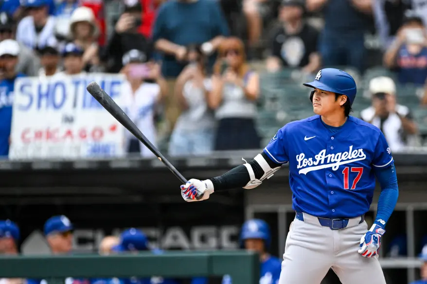 Shohei Ohtani batting in his Dodgers uniform with a "Shotime in Chicago" banner behind him.