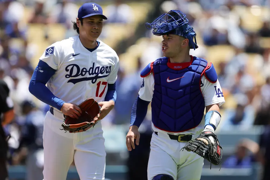 Dodgers players Shohei Ohtani and Dalton Rushing on the field.