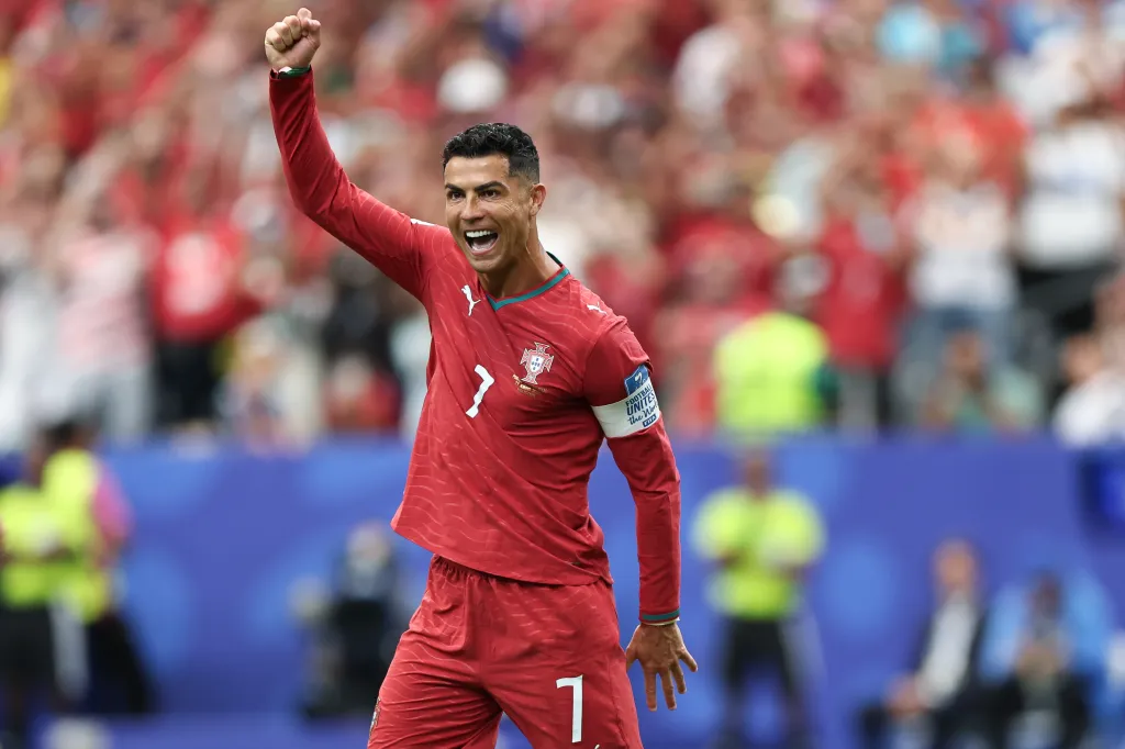 Cristiano Ronaldo, wearing a red Portugal jersey, celebrating a goal during the FIFA World Cup 2026 Group K match against Uzbekistan.