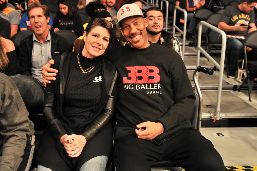 LaVar Ball and his wife Tina Ball seated together at a basketball game.