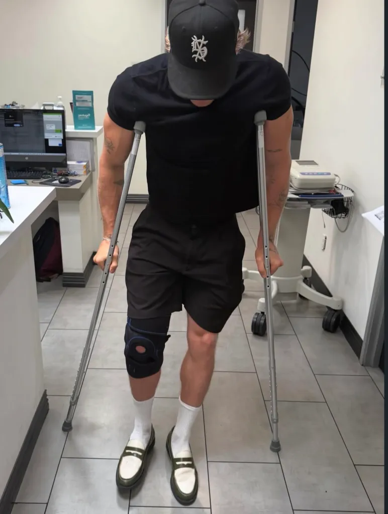 A person with a knee brace and crutches.