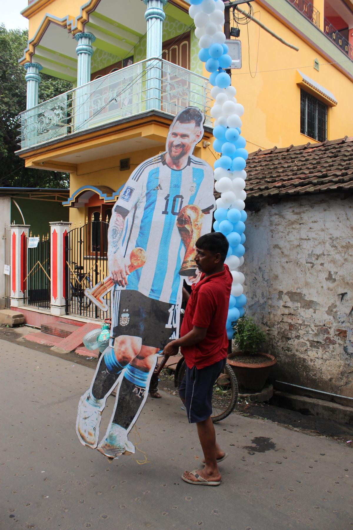 A man carries a Messi cut out in Ichhapur