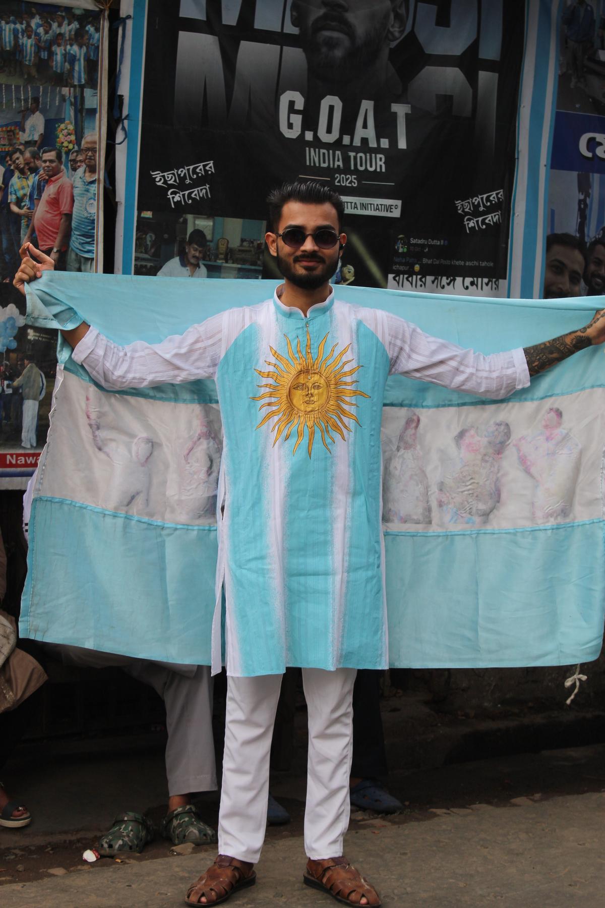 A fan wrapped in an attire resembling Argentina’s flag