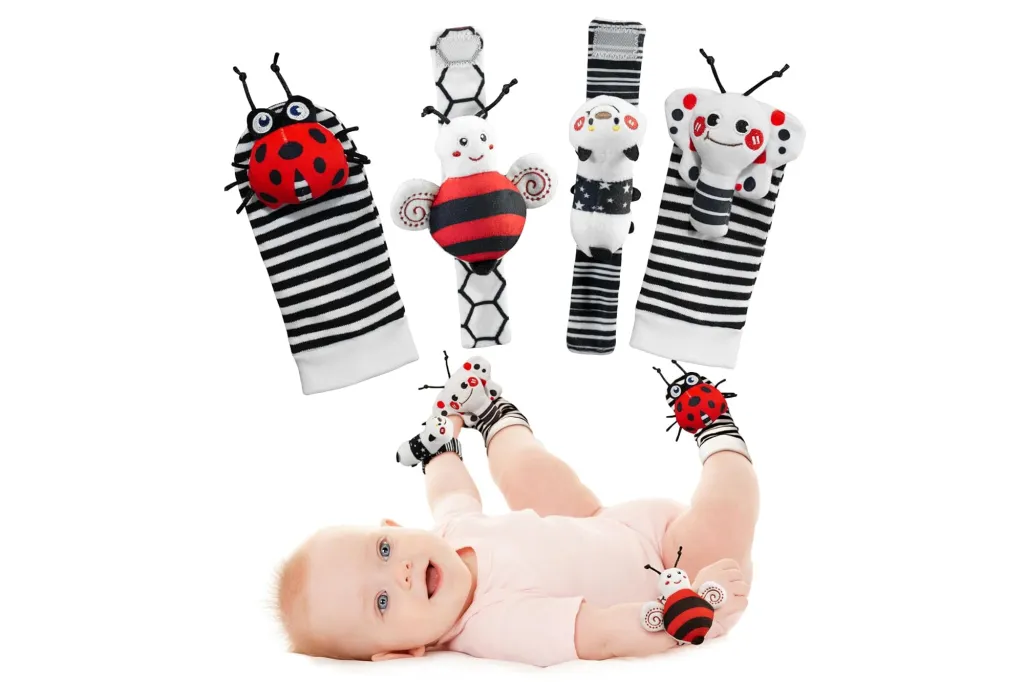 An infant playing with Infinno High Contrast Baby Toys, including rattle socks and wristbands featuring ladybugs, bees, and other creatures.