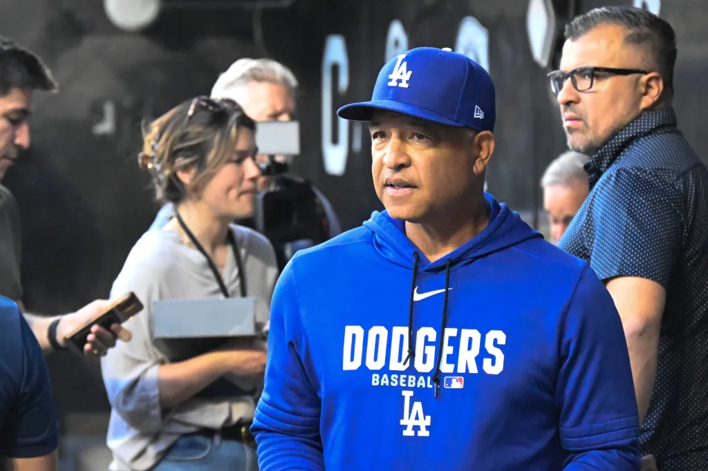 Los Angeles Dodgers manager Dave Roberts in a blue Dodgers hoodie and cap.