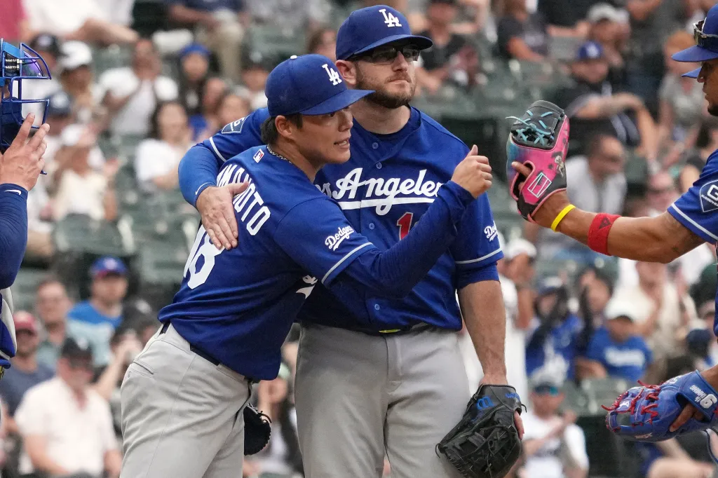 Los Angeles Dodgers players hugging each other on the field.