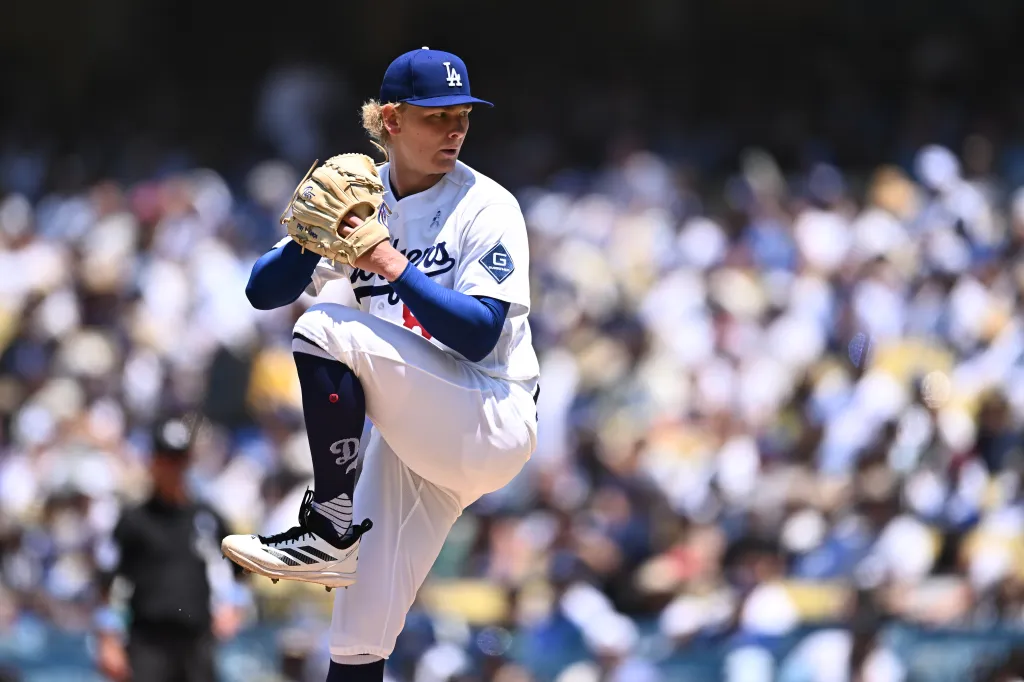 Los Angeles Dodgers pitcher in uniform pitching during a game.
