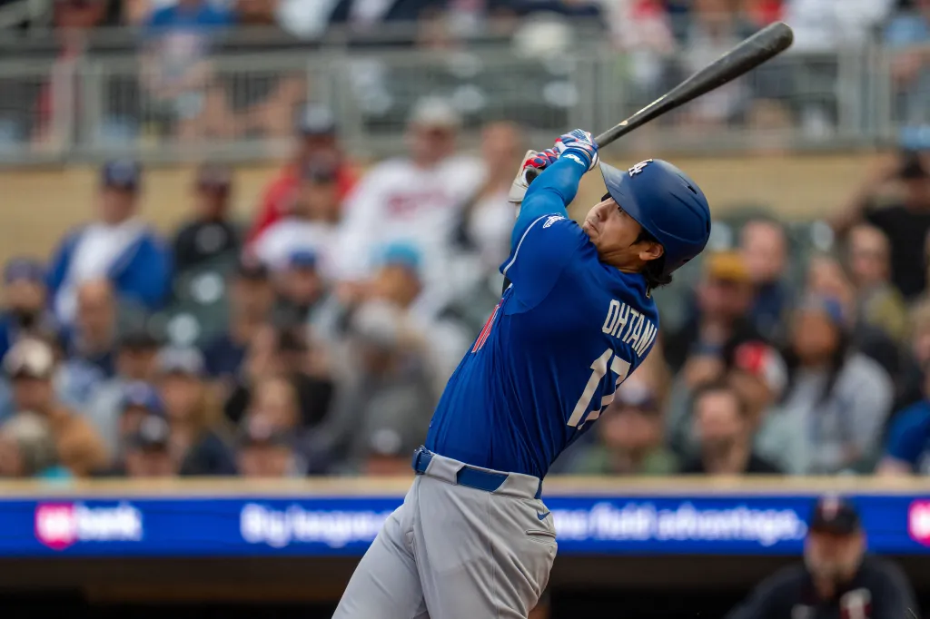 Shohei Ohtani hitting a baseball for the Los Angeles Dodgers against the Minnesota Twins.