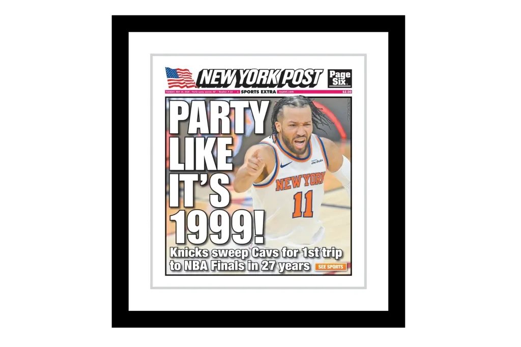 A framed newspaper cover.