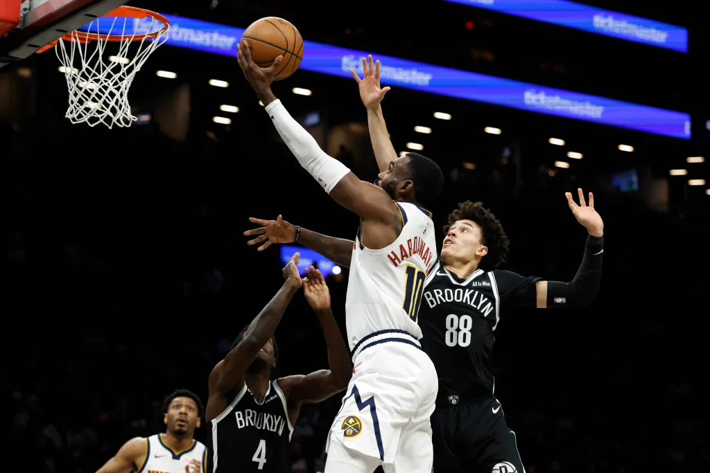 01/04/26: Tim Hardaway Jr. #10 of the Denver Nuggets puts up a shot as Drake Powell #4 of the Brooklyn Nets and Nolan Traore #88 of the Brooklyn Nets defend in the first half at the Barclays Center.