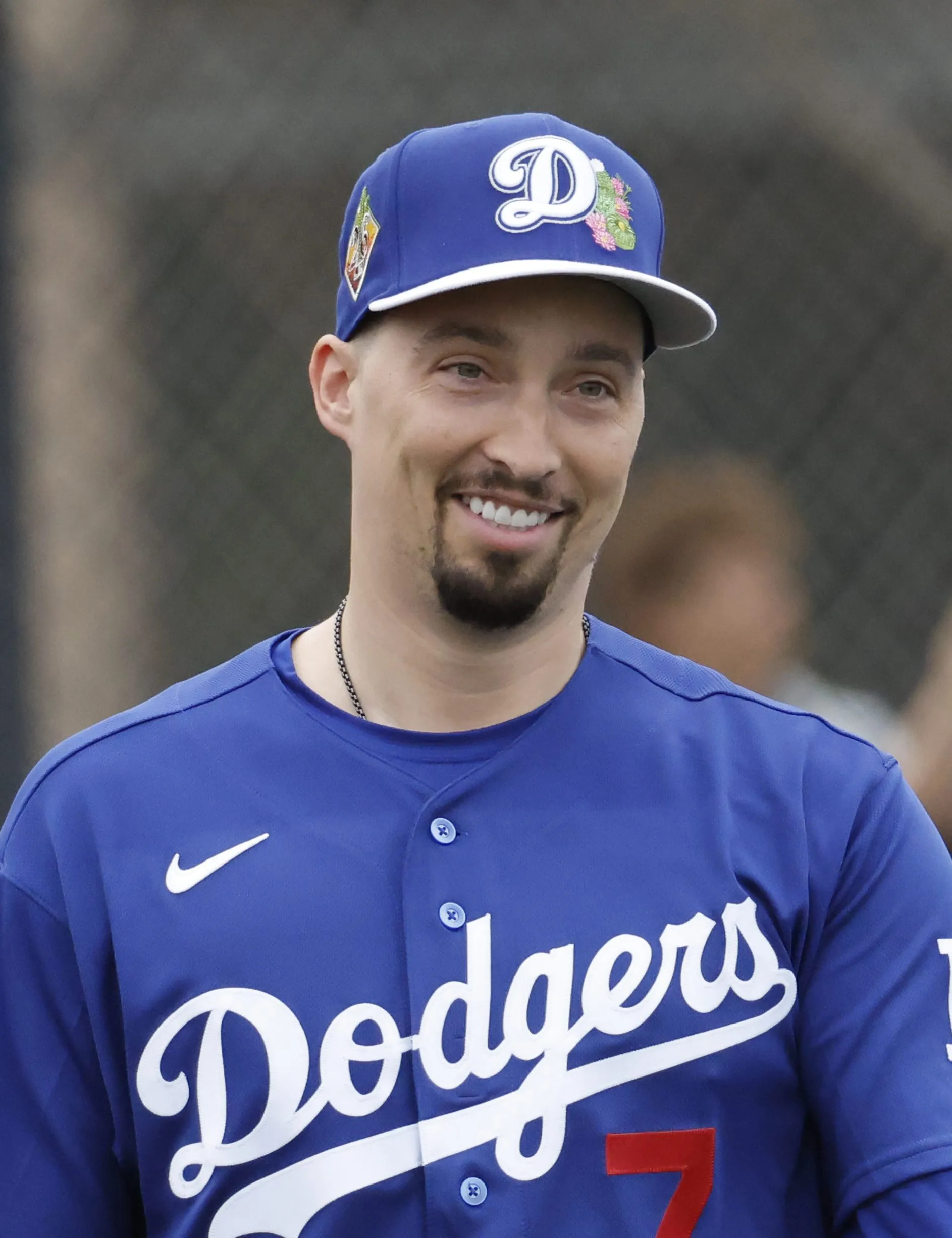 Los Angeles Dodgers player Jason Heyward smiling in his uniform during spring training.